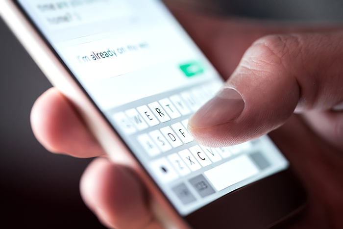 Person typing on smartphone